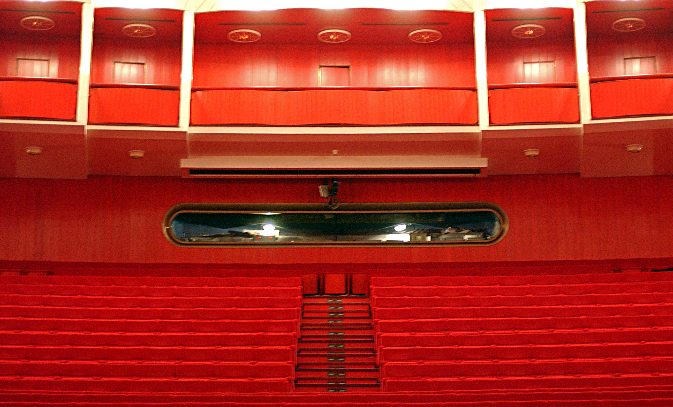 The oblong window of the lighting control booth seen from the auditorium